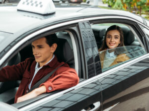 Happy female passenger riding in a taxi